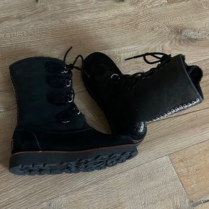 a pair of black lace up Ugg boots with black fur lining. Never worn